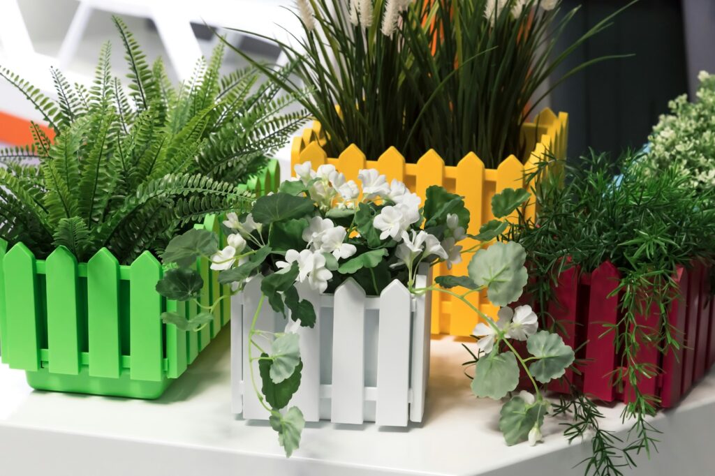 Artificial flowers in pots. Details of home and garden decor and interior
