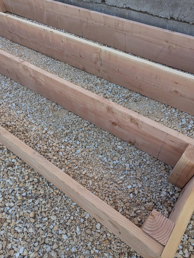 Should I remove these rocks under his planned raised bed before placing soil? – Reddit Post