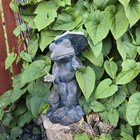 a garden ornament has accepted it's fate it seems.